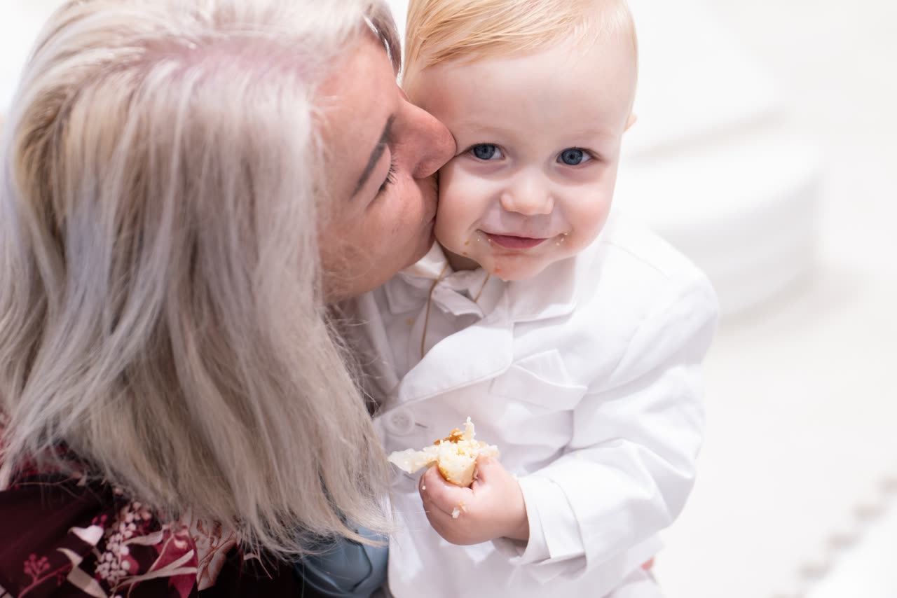 Grandparent moment photographed at a Serbian christening reception