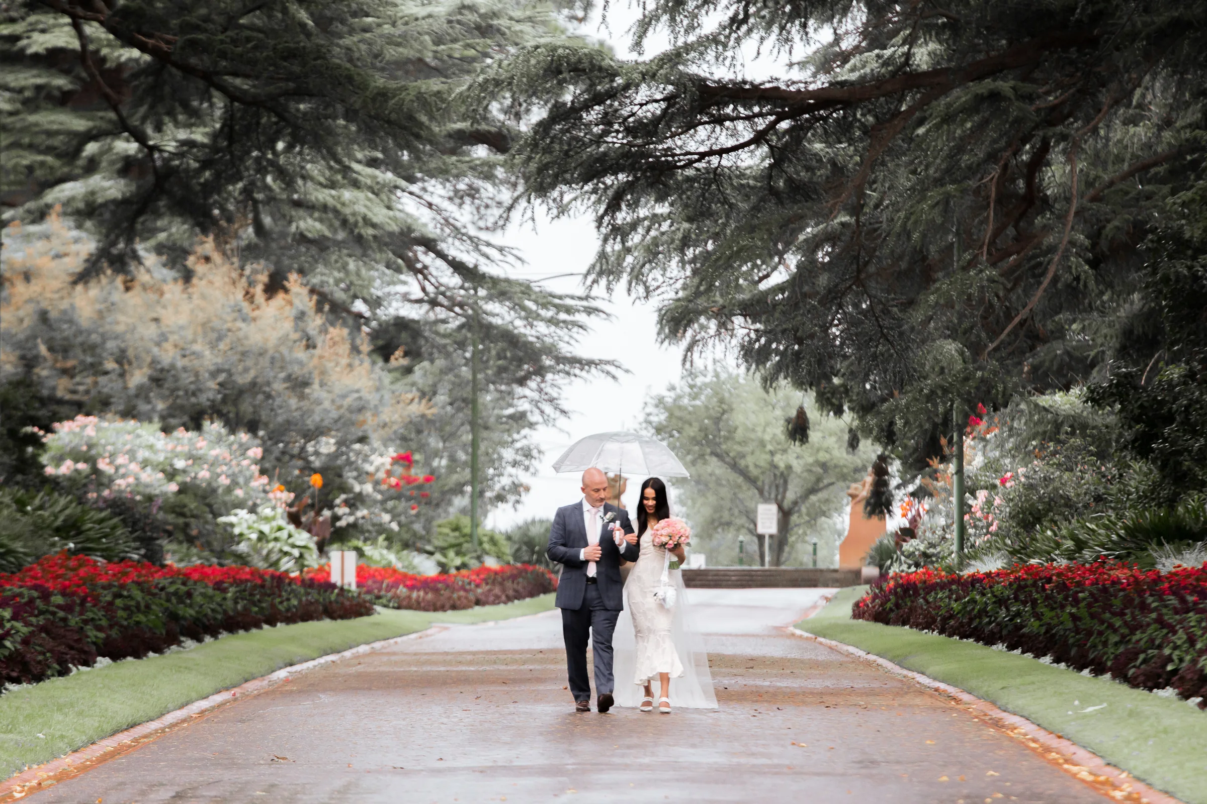 Wedding couple walking through a garden photographed by Royale Photography